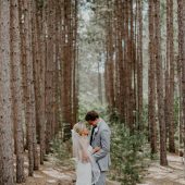 Bride and Groom posing in the woods at Michigan venue
